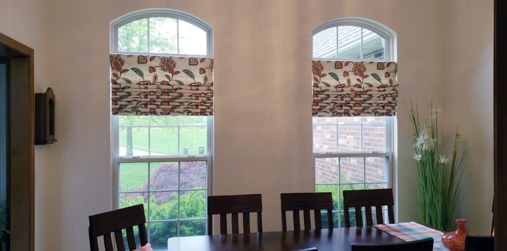 Roman shades in dining room windows.