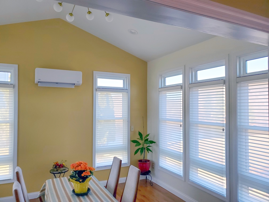 Hunter Douglas Silhouette shades installed in a yellow sunroom