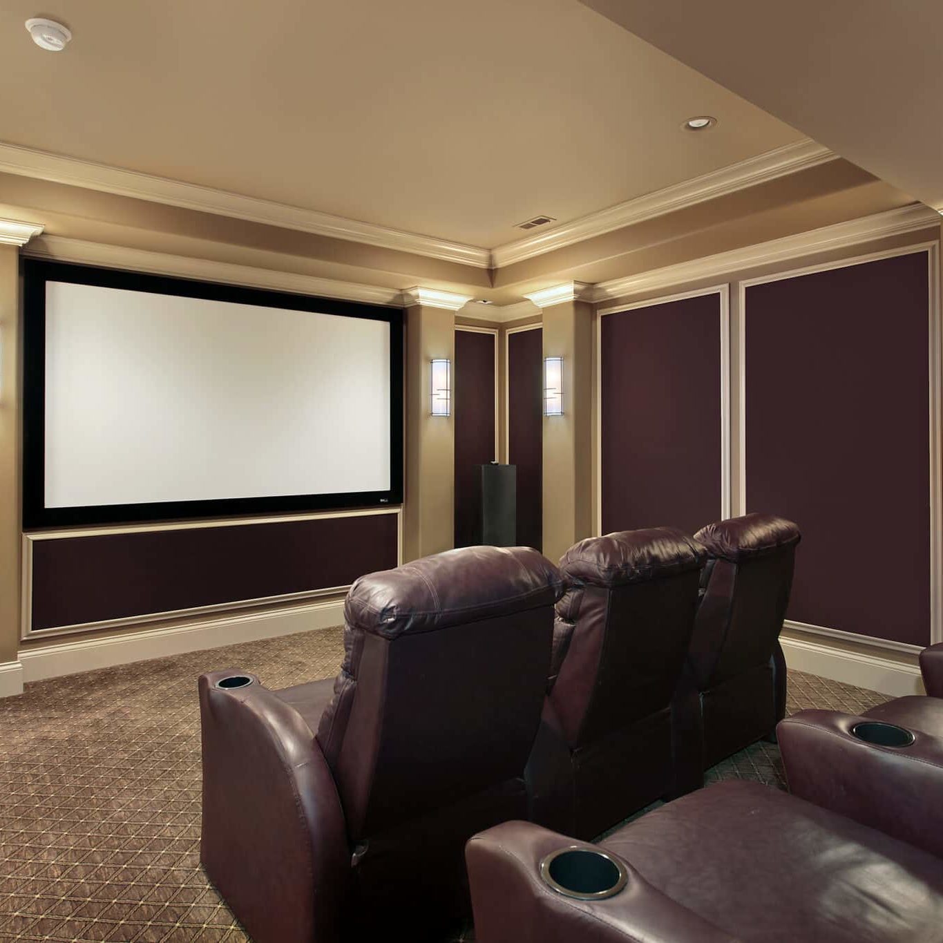 Theater room in luxury home with lounge chairs